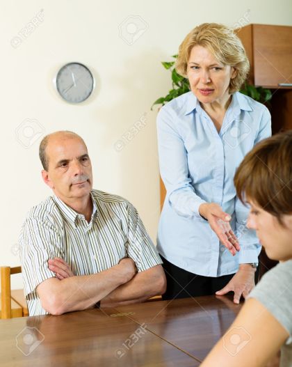 50872864-daughter-and-mature-parents-having-serious-talking-in-home-interior-Stock-Photo.jpg